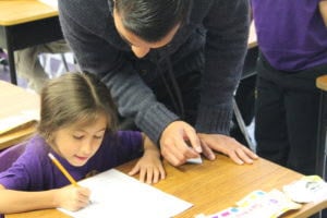 student working with teacher